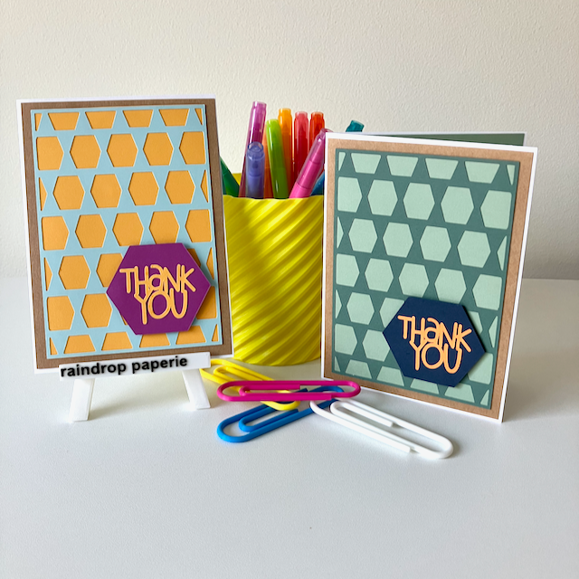 Two handmade greeting cards with geometric patterns and 'Thank You' text displayed with stationery items.