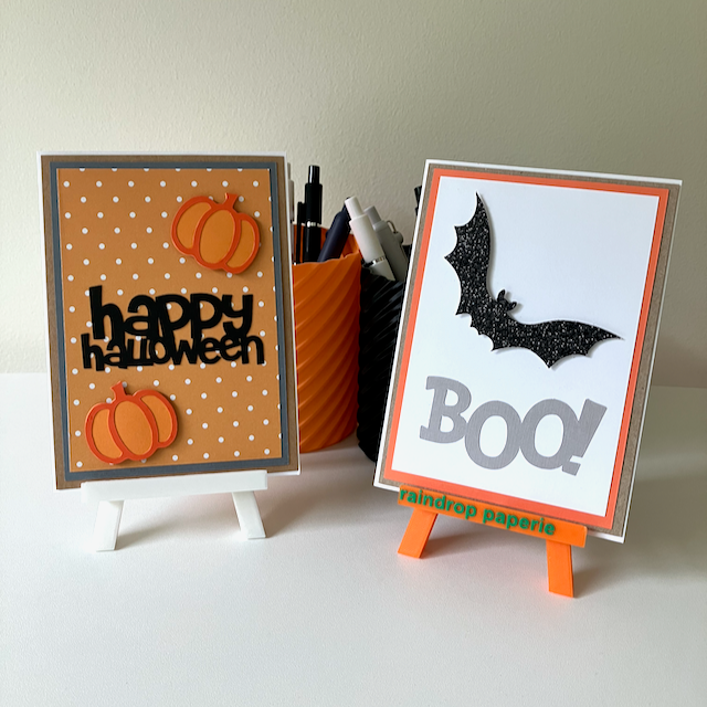Two handmade greeting cards with pumpkins and a bat.