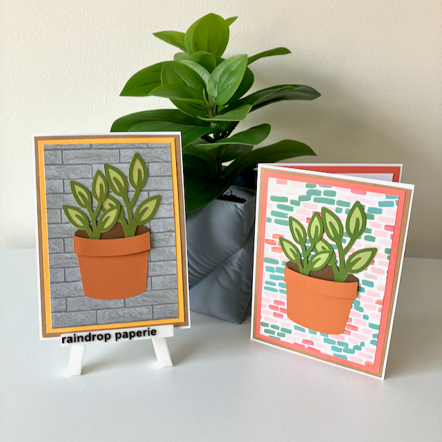 Two handmade greeting cards with a garden pot and green foliage displayed on a table.