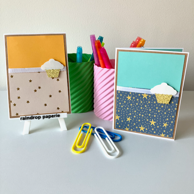 Two colorful greeting cards with decorative patterns and a pen holder filled with pens on a white surface.
