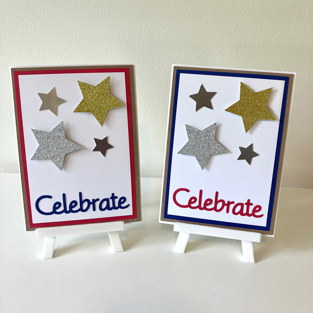 Two handmade greeting cards on easels that say Celebrate with glitter stars