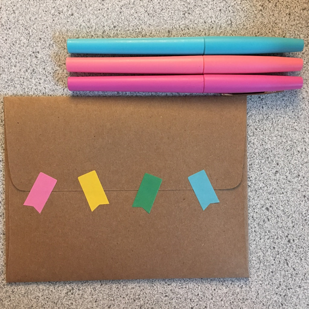 Kraft envelope with stickers and markers.