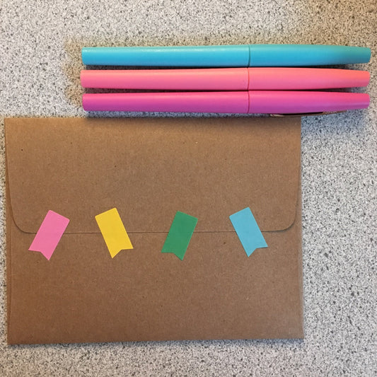 Kraft envelope with stickers and markers.