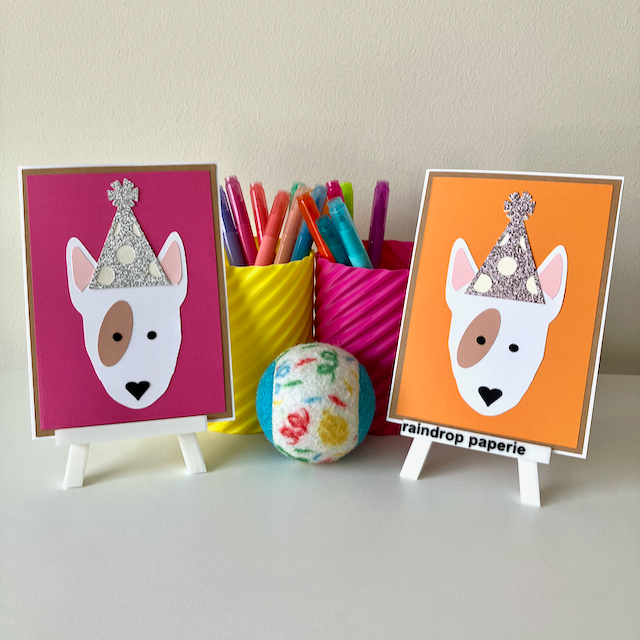 Two handmade greeting cards with English Bull Terriers wearing birthday hats.