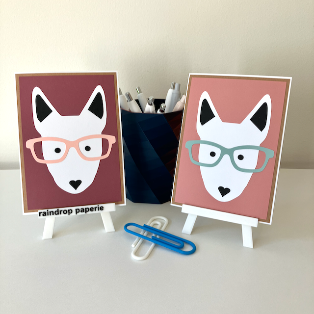 Two handmade greeting cards with English Bull Terrier faces wearing glasses. 