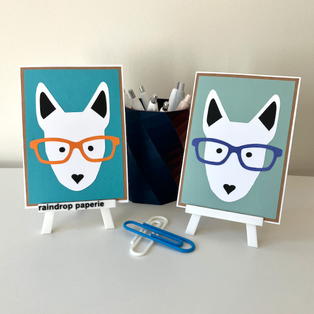 Two handmade greeting cards with English Bull Terrier faces wearing glasses. 