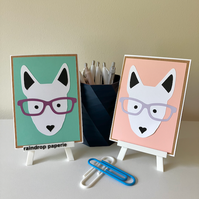 Two handmade greeting cards with English Bull Terrier faces wearing glasses. 