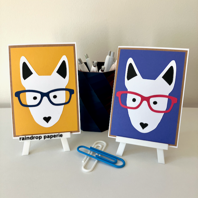 Two handmade greeting cards with English Bull Terrier faces wearing glasses. 
