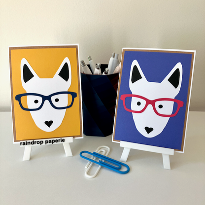 Two handmade greeting cards with English Bull Terrier faces wearing glasses. 