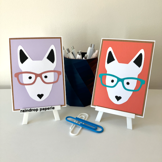 Two handmade greeting cards with English Bull Terrier faces wearing glasses. 