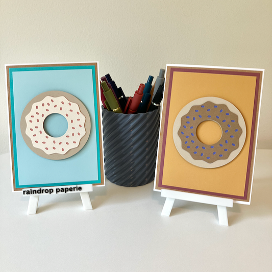 Two handmade greeting cards with donuts on the front. 