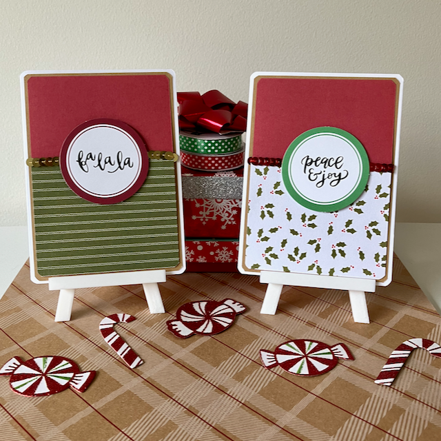 Two Christmas-themed greeting cards on mini easels with decorative ribbons and candy canes in the background.
