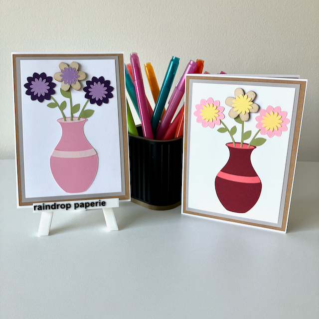 Two handmade greeting cards with vases and flowers in bright colors.