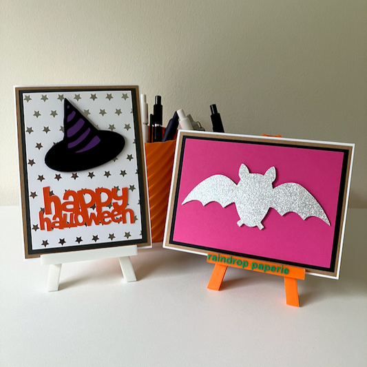 Two handmade greeting cards with a witches hat and a bat.