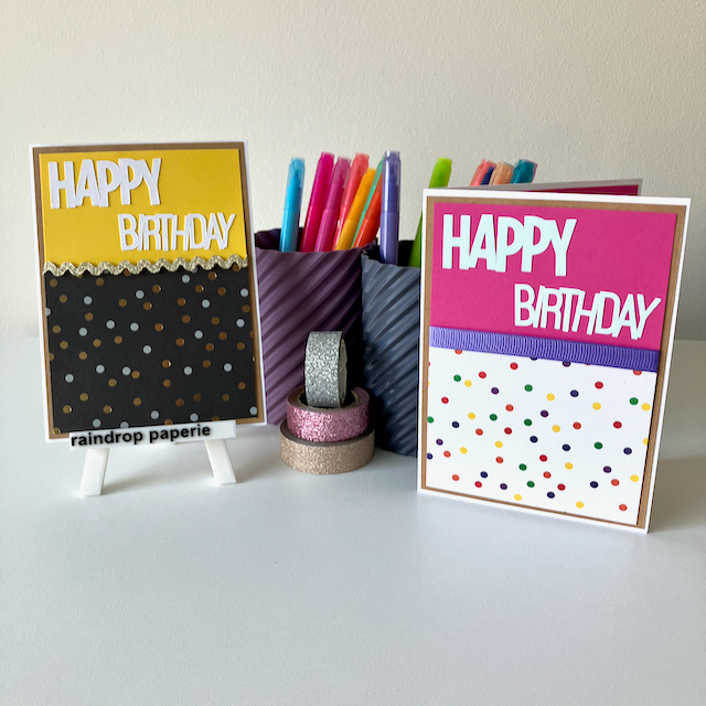Two 'Happy Birthday' cards with polka dot patterns on a white surface with stationery items.