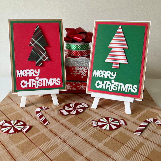Two Christmas-themed cards on stands with decorative ribbons and candy canes on a checkered surface.