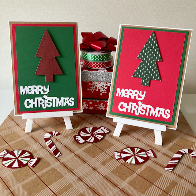 Two Christmas-themed greeting cards on stands with decorative ribbons and candy canes on a checkered surface.
